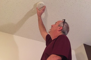 Sachse resident Larry Mitchell replaces the batteries in smoke alarms at his home.