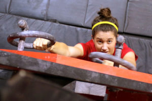 Woodcock tests her upper body strength on a ring-based wall climb.